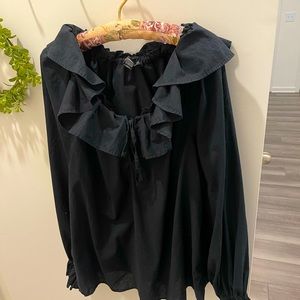 Black frilly girly that gray top with jeans